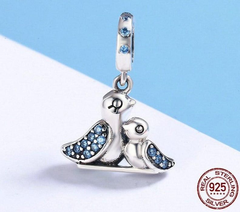 Silver bird charm with blue cubic zirconia