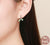 Model wearing plant leaves earrings